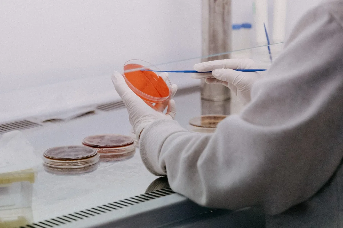 Researcher taking notes at a laboratory bench
